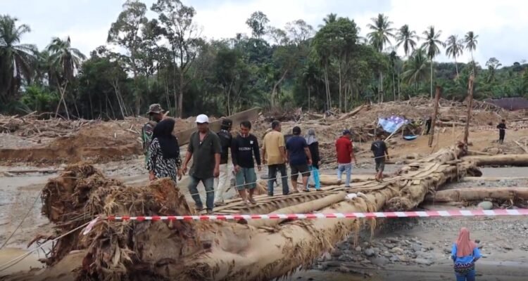 FOTO 15 Des_Warga melintasi jembatan darurat di Desa Garoga, Kecamatan Batang Toru, Tapanuli Selatan.